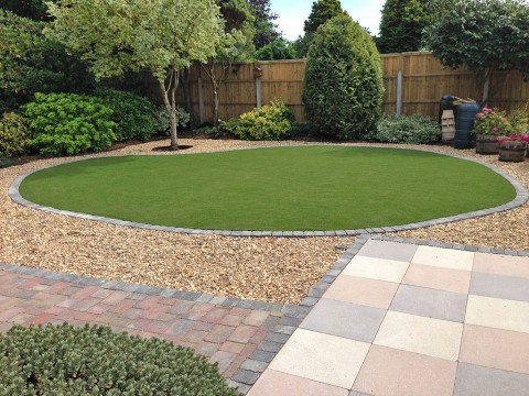 Landscaping in Barton on Sea. Artificial grass before being cut in for easy maintenance.